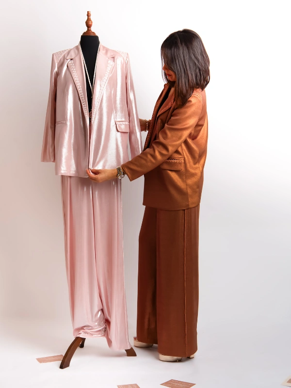 Laissez-vous séduire par le Tailleur veste-pantalon, avec un tombé fluide et aérien, fusion parfaite entre le vestiaire contemporain et le savoir-faire artisanal marocain. Conçu dans une matière fluide et stretch, il offre un confort absolu tout en épousant divinement les lignes de votre corps. Un confort extensible sans compromis sur le glamour.